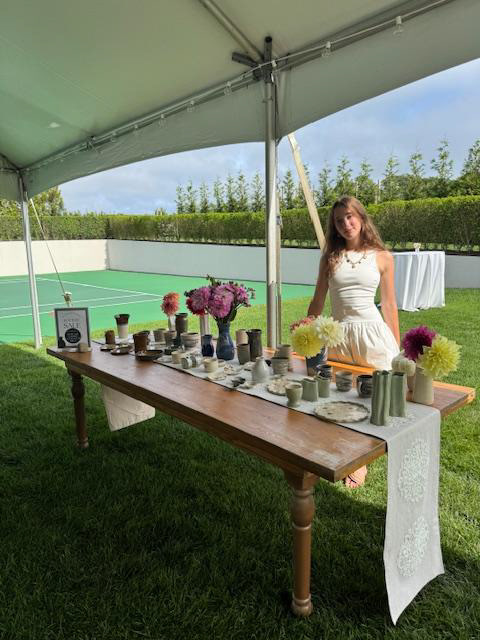 Edie at outdoor pottery table
