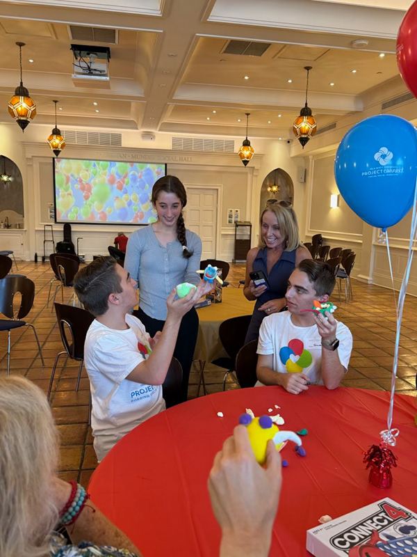 Edie teaching pottery at Project Connect