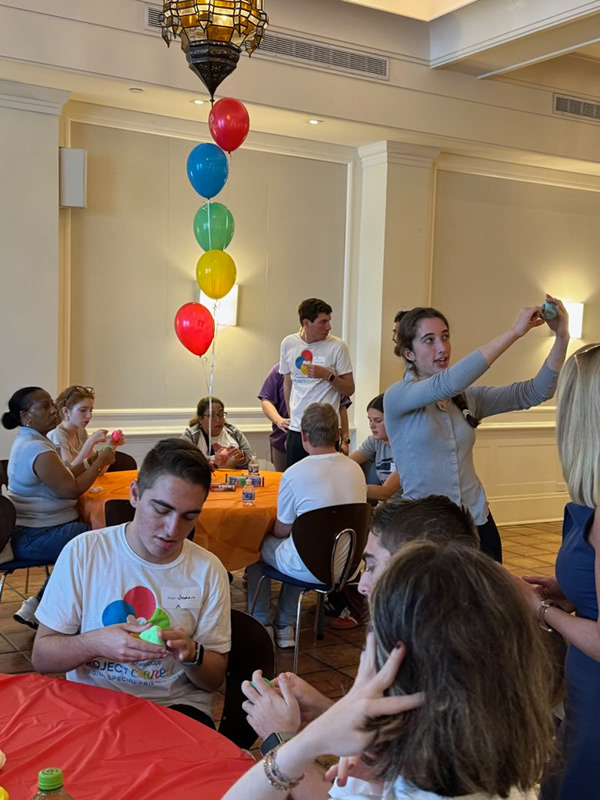 Edie demonstrating pottery at Project Connect